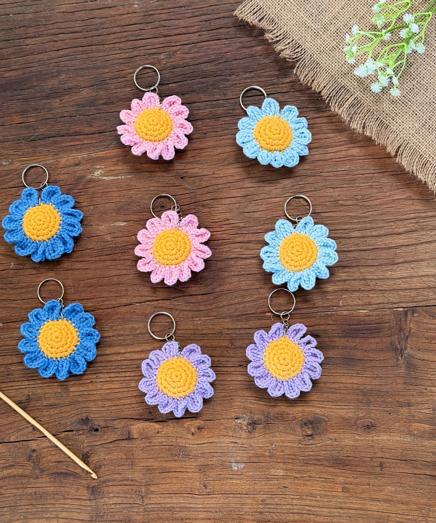 Handmade crochet sunflower keychains in bright yellow and brown tones, crafted from soft yarn and designed as cheerful handmade gifts by Hanneaise Handmade.