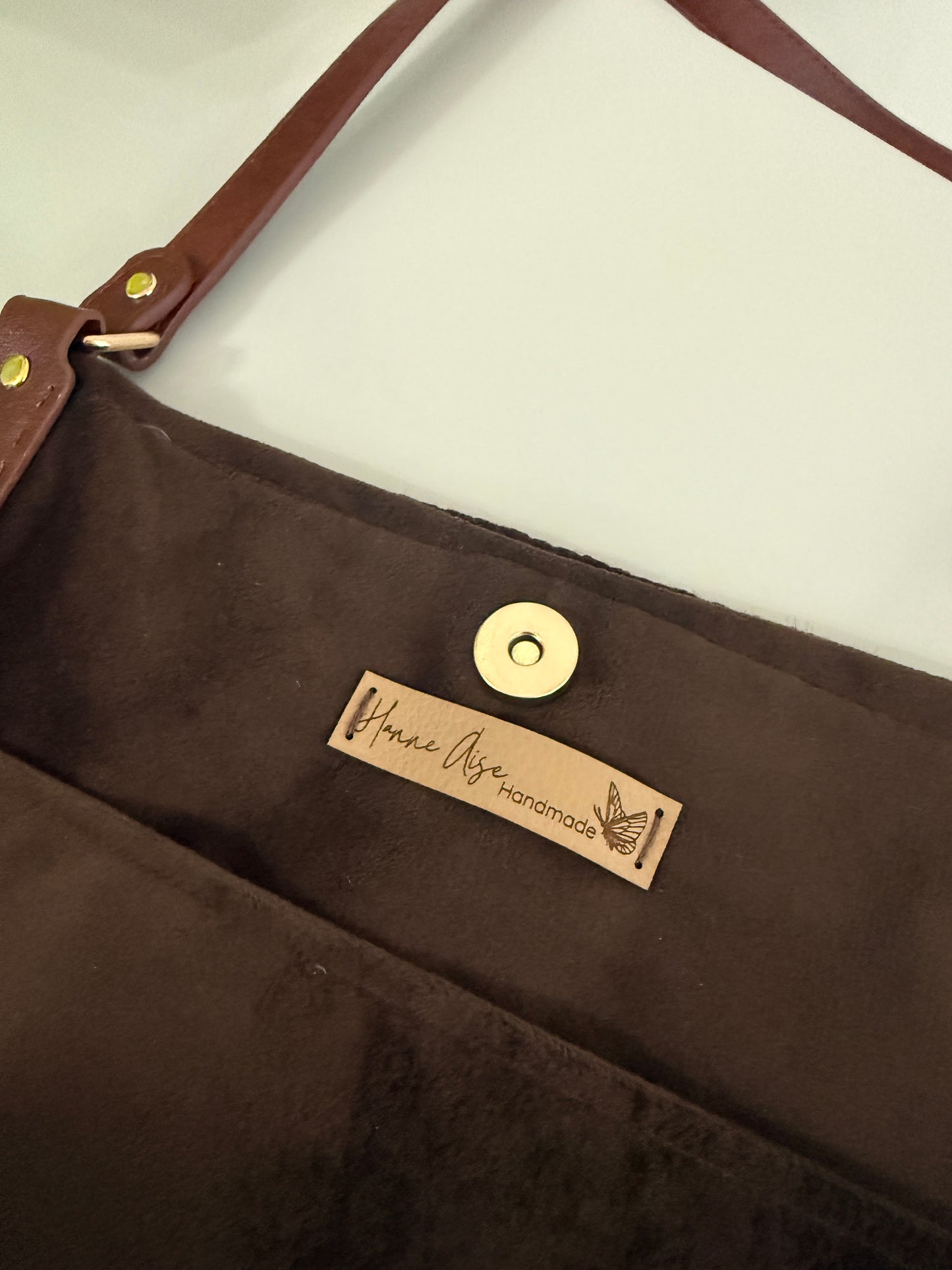 Velvet lined crochet tote bag with Hanne Aise Handmade label and magnetic snap closure