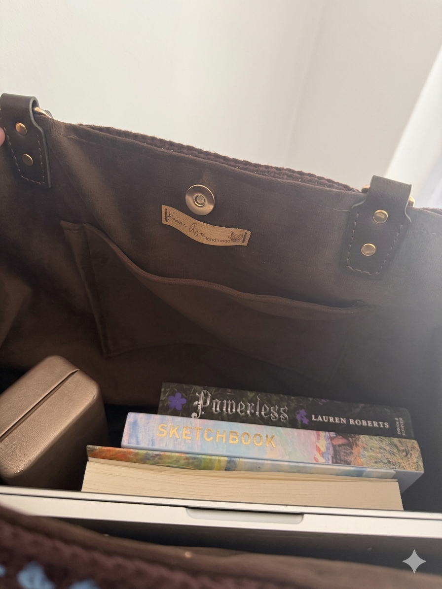 Interior of large crochet tote bag showing velvet lining, inner pocket and spacious capacity
