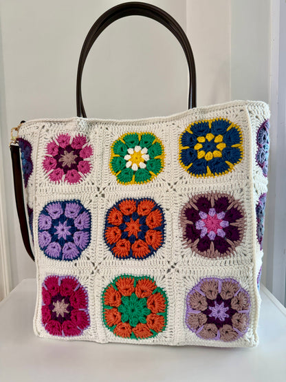 Cream granny square crochet tote bag with brown handles and colourful handmade floral motifs