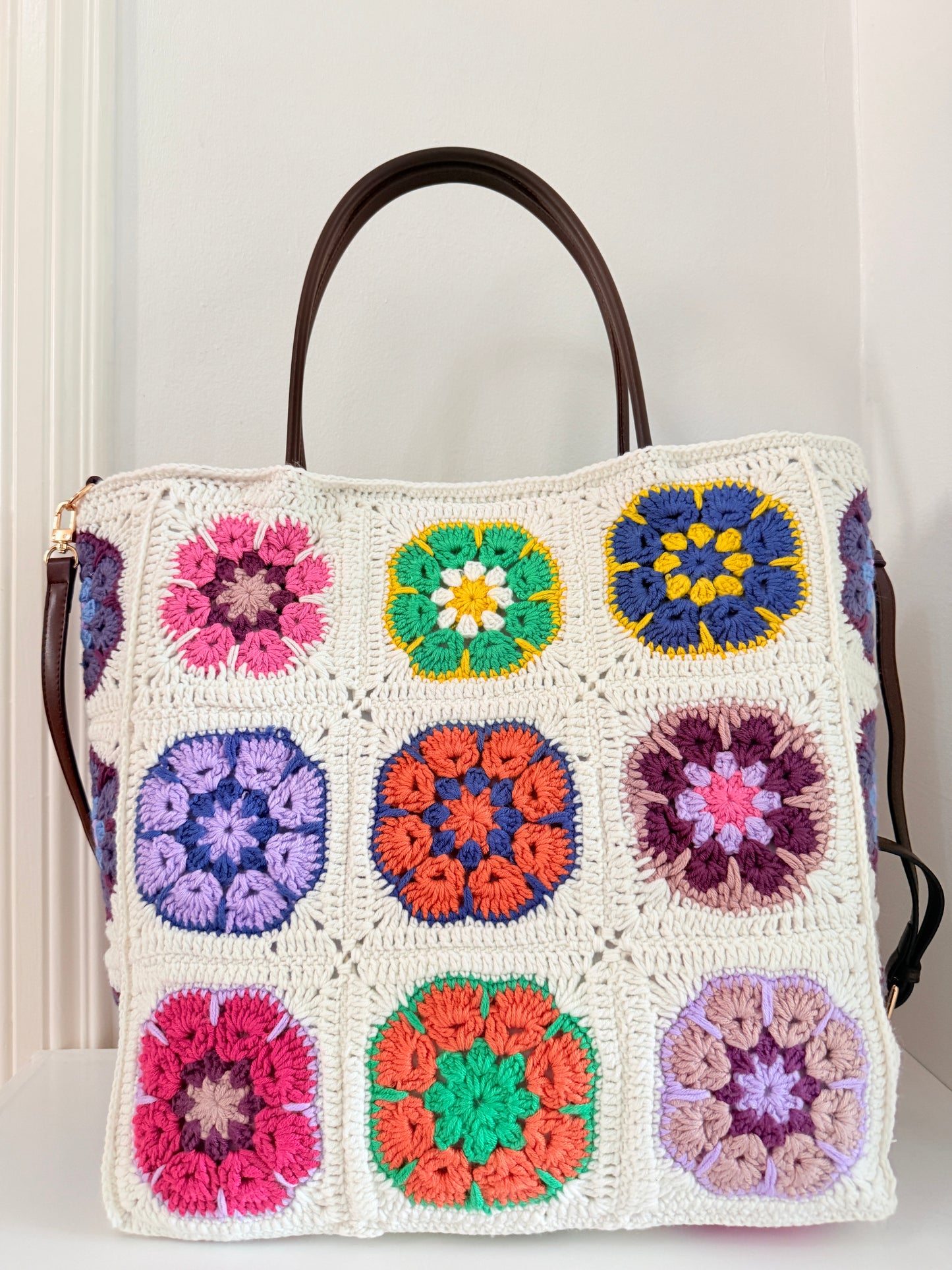 Large colourful granny square crochet shoulder bag with cream crochet base and floral pattern