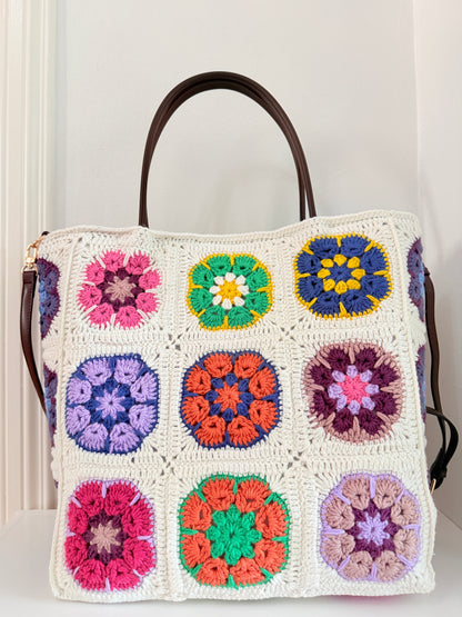 Large colourful granny square crochet shoulder bag with cream crochet base and floral pattern