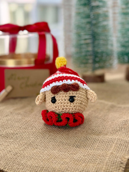 Crochet elf ornament with striped red and white hat – handmade cotton Christmas bauble decoration.
