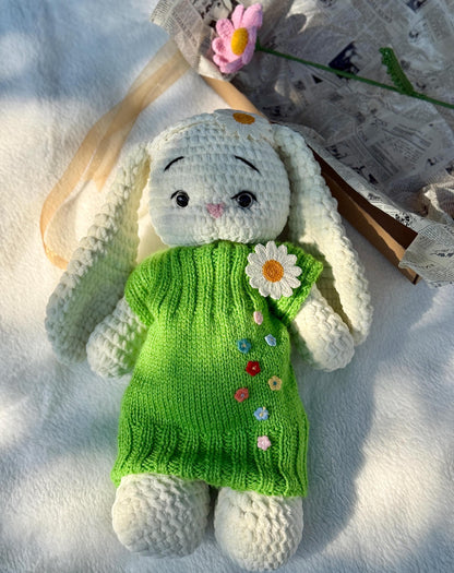 Handmade crochet bunny wearing green daisy dress, perfect for spring baby gifts.