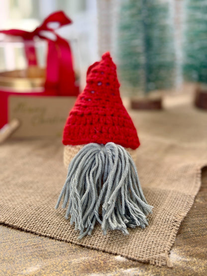 Crochet gnome Christmas bauble with red hat and grey beard – handmade cotton ornament for holiday decor.