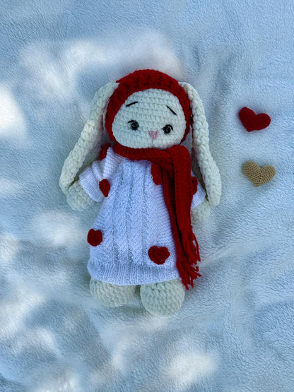 Crochet bunny with red scarf and white dress featuring red heart appliqués.