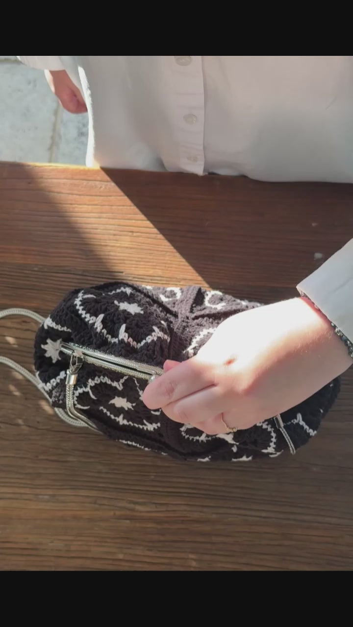 Handmade black crochet kiss lock handbag with silver chain strap, metal frame and lined interior